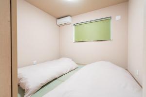 Postel nebo postele na pokoji v ubytování Fuji Fabric Stay