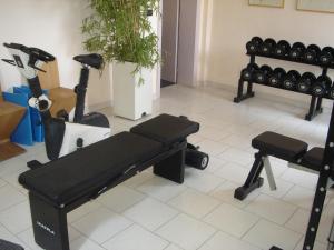 a room with a gym with a bench and guitars at Park Hotel Miriam in Gatteo a Mare