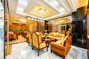 a living room with couches and a table and chairs at Nicecy Saigon Hotel in Ho Chi Minh City