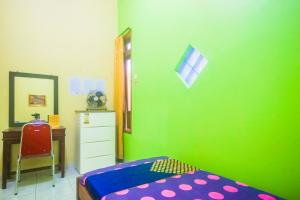 Postel nebo postele na pokoji v ubytování OYO 2440 Wallet Family Residence Syariah
