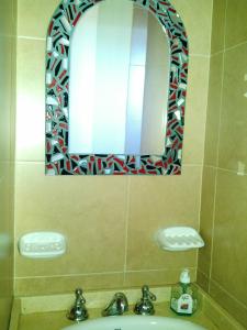 a bathroom with a sink and a mirror at Departamento a 1 cuadra de calle Aristides in Mendoza