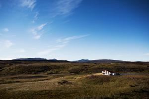 a small house in the middle of a field at Hotel Gullfoss in Haukadalur