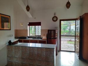 a kitchen with a refrigerator and a counter top at Villa Mayfair in Cavelossim