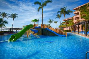 a water park with a slide in a swimming pool at Barceló Huatulco - All Inclusive in Santa Cruz Huatulco