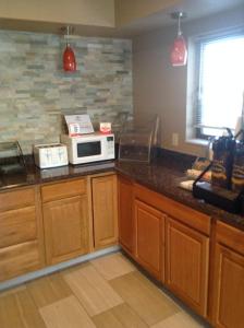 a kitchen with a counter with a microwave on it at Super 8 by Wyndham Story City in Story City
