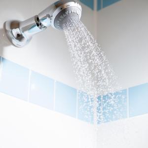 a shower head with water coming out of it at Leonardo Hotel Dublin Christchurch in Dublin