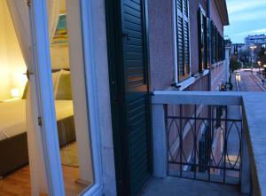 a door to a balcony with a view of a street at A&M Apartment and Rooms in Split