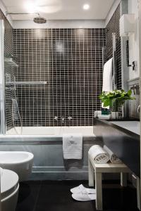 a bathroom with a tub and a toilet and a sink at Casa Montani in Rome +78 photos