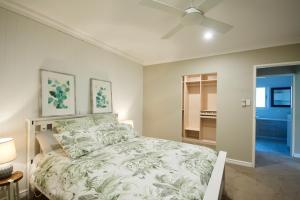 a bedroom with a bed and a ceiling fan at Red Tail Retreat in Collie