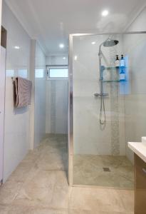a shower with a glass door in a bathroom at Red Tail Retreat in Collie