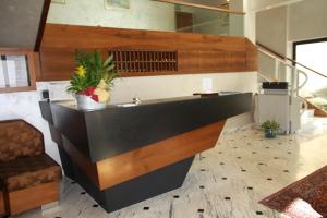 a kitchen with a counter with a sink in a room at Hotel Iris in Genoa