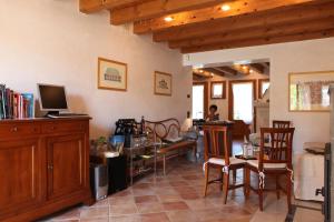 a living room with a table and chairs and a tv at Agriturismo Marani in Arcugnano