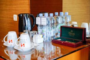a glass counter with glasses and a box on it at Swiss-Belhotel Kendari in Kendari