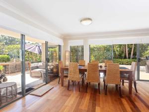 a dining room with a table and chairs at Peninsula Waters 1 Aircon pool and massive outdoor area in Soldiers Point