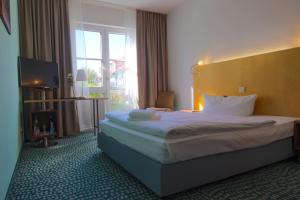 Postel nebo postele na pokoji v ubytování Check Inn Hotel Merseburg