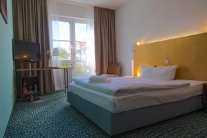 
Ein Bett oder Betten in einem Zimmer der Unterkunft Check Inn Hotel Merseburg
