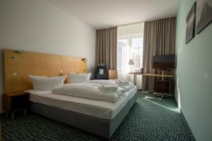 Postel nebo postele na pokoji v ubytování Check Inn Hotel Merseburg