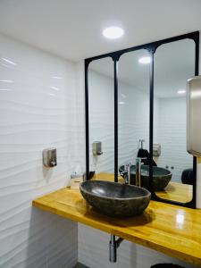 a bathroom with a large stone sink on a counter at Poveira Hotel in Porto +44 photos