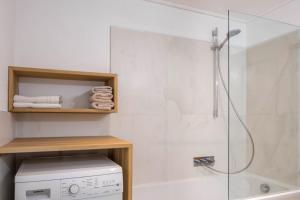 a bathroom with a shower and a washing machine at App Schlern - Gasser in Vols am Schlern +13 photos