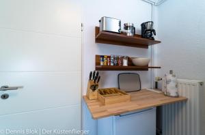 a small wooden shelf on a door with a knife holder at Möwennest 3 in Emden