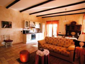 a living room with a couch and a kitchen at Agriturismo Istrice Innamorato in Campello sul Clitunno