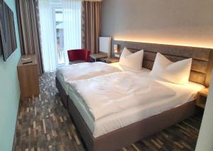 Postel nebo postele na pokoji v ubytování WILLINO Privathotel