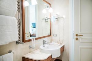 a bathroom with a sink and a mirror at Grand Hotel Terme Sirmione in Sirmione
