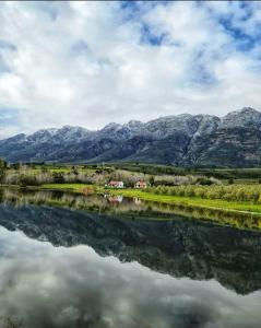 a reflection of mountains in a body of water at Fraaigelegen Farm - Home of ADHARA EVOO in Tulbagh
