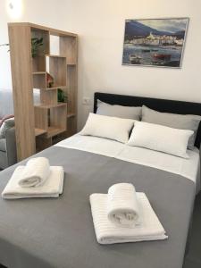 a bedroom with two beds with white towels on them at Sweet Dreams - Studio Apartment in Dubrovnik