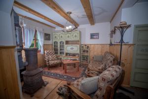 a living room with a couch and a stove at ZSUZSI-LAK in Sub Cetate