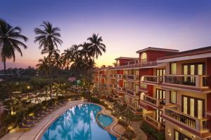 an aerial view of a resort with a pool and palm trees at Lazy Lagoon, Baga A Lemon Tree Resort, Goa in Baga