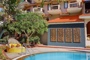 a resort with a swimming pool in front of a building at Lazy Lagoon, Baga A Lemon Tree Resort, Goa in Baga