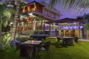 a resort with tables and chairs and a pool table at Lazy Lagoon, Baga A Lemon Tree Resort, Goa in Baga