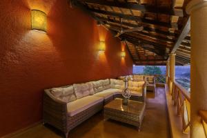 a living room with a couch and a table at Lazy Lagoon, Baga A Lemon Tree Resort, Goa in Baga