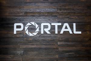 a sign on a wooden wall with the word portal at Hotel Portal in Maykop