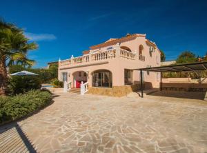 a large house with a patio in front of it at Villa Nerea - Plusholidays in Calpe