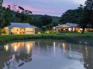 a house with a pond in front of it at Chicane Bed and Breakfast in Sunland