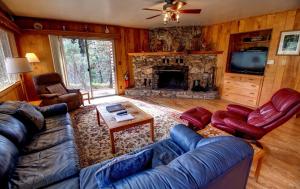 a living room with a couch and a fireplace at 17A Longview in Wawona