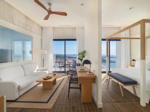a living room with a couch and a table at H10 Imperial Tarraco 4 Sup in Tarragona