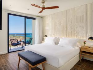 a bedroom with a bed and a view of the ocean at H10 Imperial Tarraco 4 Sup in Tarragona