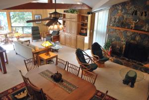 a living room with a table and a stone wall at 18A Pohono Pines in Wawona