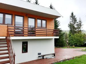 a house with a deck on the side of it at U Górala Tadzia in Krynica Zdrój