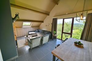 a living room with a couch and a table at Résidences Durbuy in Durbuy