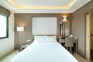 Säng eller sängar i ett rum på Sleep Hotel Bangkok