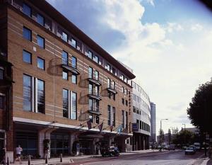 a large brick building on a city street at Novotel London Waterloo in London