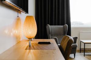 a living room filled with furniture and a lamp at Hotel Katla by Keahotels in Vík