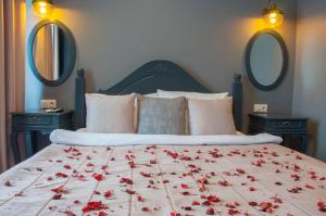 a bedroom with a bed with red flowers on it at Room Room Hotel in Sapanca