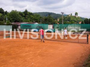 a couple of people standing on a tennis court at Penzion Topas in Bylnice