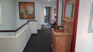 an office hallway with white walls and a stairway at Große Ferienwohnung, auf Bauernhof mit Ponys und Pferden, ländlich und ruhig, Nähe Dümmer See in Holdorf
