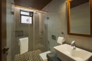 a bathroom with a sink and a shower at Lazy Lagoon, Baga A Lemon Tree Resort, Goa in Baga